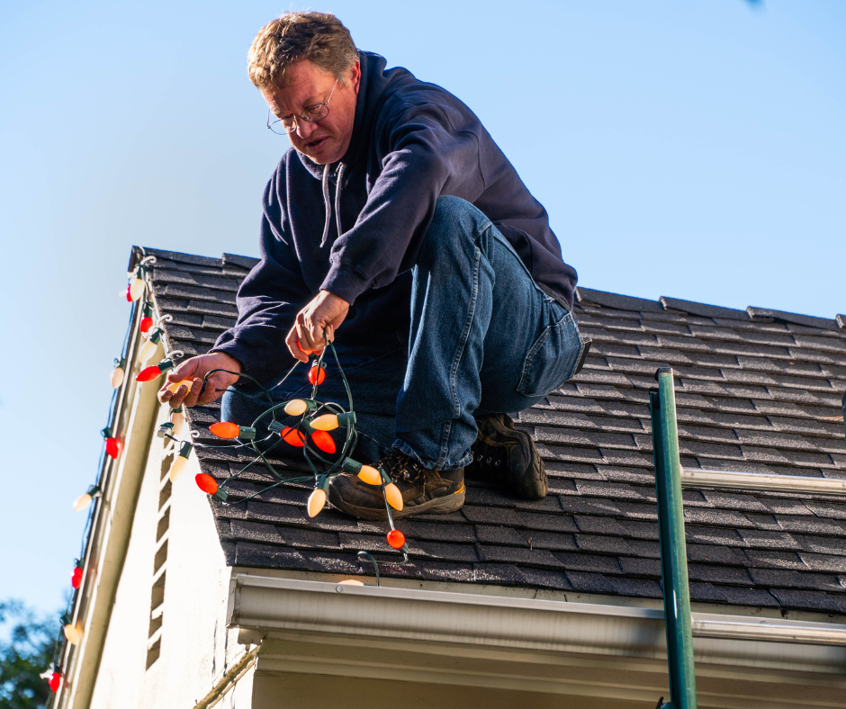 A Window Ninjas technician installing holiday lights on a home - call to book the best christmas light installers Greenville, SC.
